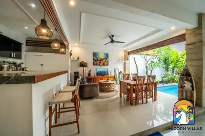 a kitchen and living room with a table and chairs at A&R4 Villa - by Unicorn Villas Bali in Seminyak