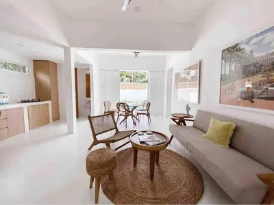 a living room with a couch and a table at The Pink Door Villa in Legian