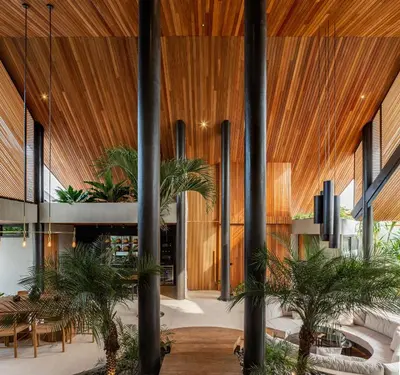 a lobby with palm trees and wooden ceilings at House of Winds Complex - Luxury 6BR Tropical Retreat - 2x3BR Villas near Canggu in Kerobokan