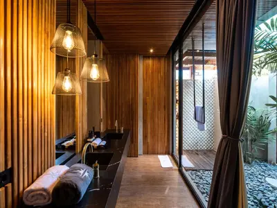 a bathroom with a tub and a sink and a window at House of Winds Complex - Luxury 6BR Tropical Retreat - 2x3BR Villas near Canggu in Kerobokan