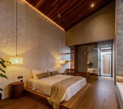 a bedroom with a large bed in a room at House of Winds Complex - Luxury 6BR Tropical Retreat - 2x3BR Villas near Canggu in Kerobokan