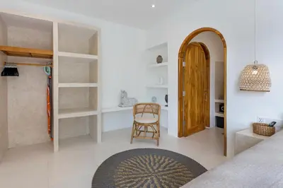 a room with a bed and a chair and a table at NEW! Villa Theo - 1BR Villa in Kerobokan in Seminyak