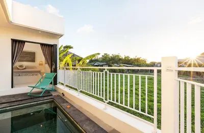 a balcony of a house with a swimming pool at NEW! Villa Theo - 1BR Villa in Kerobokan in Seminyak