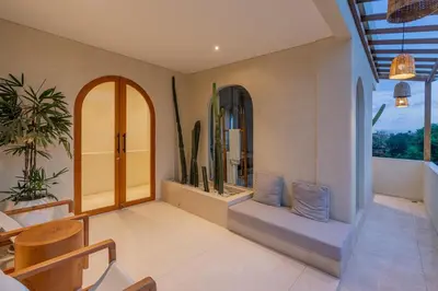 a room with a table and chairs and some plants at Villa Agua Dream Canggu hideaway in Canggu