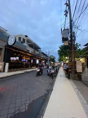 a street with motorcycles parked on the side of the road at Cozy room Kuta - 1 minutes to the beach by Micky Studio2 in Legian