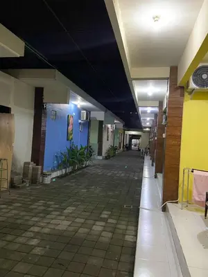 an empty hallway of a building with a blue ceiling at Cozy room Kuta - 1 minutes to the beach by Micky Studio2 in Legian