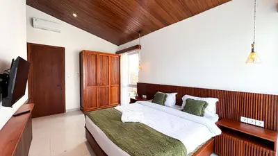 a bedroom with a large bed and a television at Casa De Vero Amore in Jimbaran