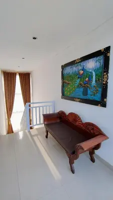 a living room with a couch and a painting on the wall at Villa Velia 3BR private pool in Badung