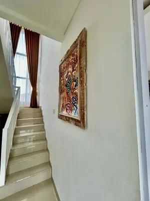 a painting hanging on a wall next to a staircase at Villa Velia 3BR private pool in Badung
