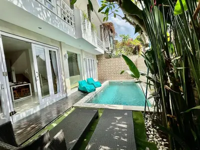 a swimming pool in front of a house at Villa Velia 3BR private pool in Badung