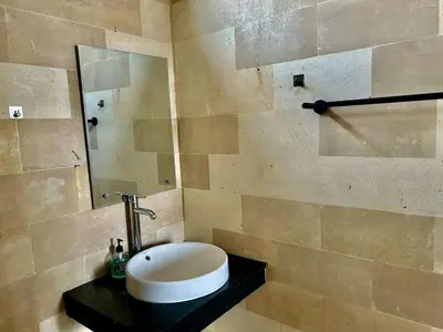 a bathroom with a sink and a mirror at Villa Velia 3BR private pool in Badung