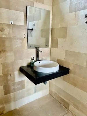 a bathroom with a sink and a mirror at Villa Velia 3BR private pool in Badung