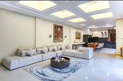 a living room with a couch and a table at Elf Belly 4 BR Canggu Heart Vila CYN in Canggu