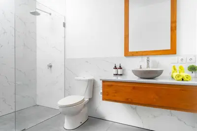 a bathroom with a toilet and a sink and a shower at Villa Damai Canggu in Seminyak