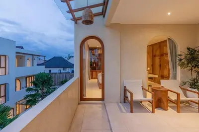 a balcony of a house with a table and chairs at Villa Viento Tropical Haven Canggu in Canggu