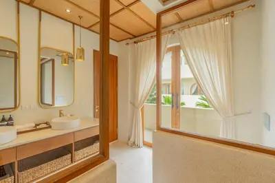 a bathroom with two sinks and a large window at Villa Viento Tropical Haven Canggu in Canggu