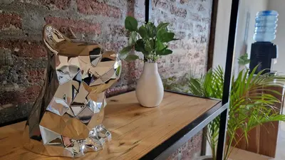 a vase sitting on a table with a white vase at Nice Place To Stay - Rooftop Apartments in Seminyak