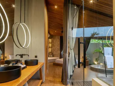a bathroom with two sinks and a mirror at House of Winds Complex - Lush 9BR Exotic Escape - 3x3BR Villas near Canggu in Kerobokan