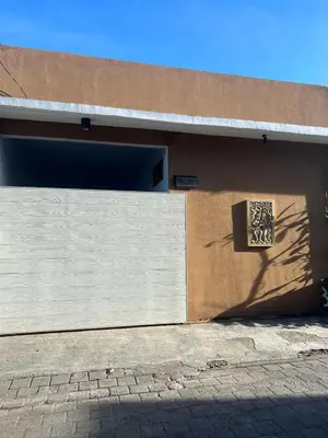 a building with a garage door and a window at Erindra Villa in Pesanggaran