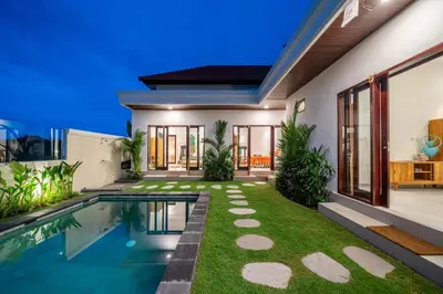 a house with a swimming pool and a yard at Nooky 4 - Villa with Spectacular Views in Kerobokan