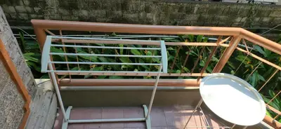 a metal bench with a toilet sitting on a porch at The Palmana Tropical Roofline Jayakarta Residence 40 in Badung