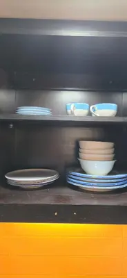 a shelf with plates and bowls on top at The Palmana Tropical Roofline Jayakarta Residence 40 in Badung