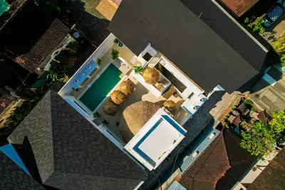 an overhead view of a house with a swimming pool at Antana Hotel in Canggu