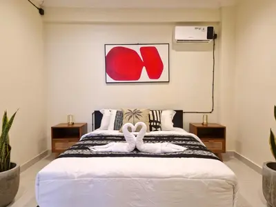 a bedroom with a bed with two white towels on it at Nice Place To Stay - Cozy Living in Seminyak