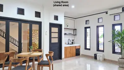 a dining room with a table and chairs at Nice Place To Stay - Cozy Living in Seminyak