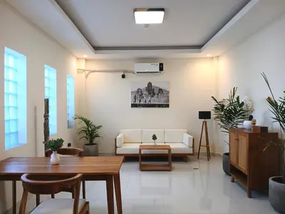 a living room with a white couch and a table at Nice Place To Stay - Cozy Living in Seminyak