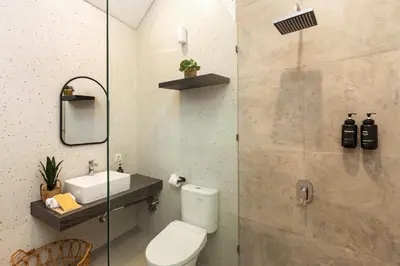 a bathroom with a toilet and a sink at Villa Lavinia - Private Pool Villa - Seminyak Kuta - Double Six Beach in Seminyak