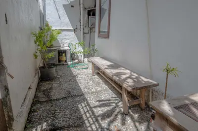 a wooden bench sitting in a room with plants at Mirri House Kerobokan in Seminyak