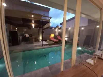 a view of a swimming pool through a window at PalmA Private Villa - A Leafy Place in Mumbul Hill in Nusa Dua