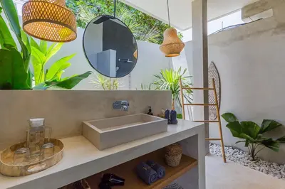 a bathroom with a sink and a mirror and plants at Villa Jazz 3BR 10m Pool seminyak in Seminyak