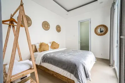 a white bedroom with a bed and a ladder at Proart 2 - Your Bali Home Away from Home - Roomy, Scenic, Relaxing in Nusa Dua