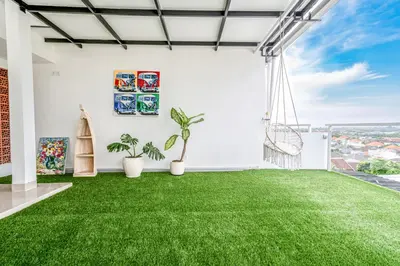 a living room with green grass on the floor at Proart 2 - Your Bali Home Away from Home - Roomy, Scenic, Relaxing in Nusa Dua