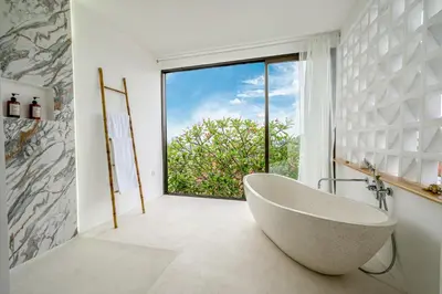 a bathroom with a tub and a large window at Proart 2 - Your Bali Home Away from Home - Roomy, Scenic, Relaxing in Nusa Dua
