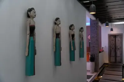 a group of mannequins on display on a wall at Bali paradise Rosa in Seminyak