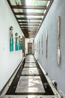 a hallway with figurines on the side of a wall at Bali paradise Rosa in Seminyak