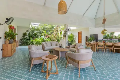 a living room with chairs and tables and a room with plants at Villa Jinjah Soul Luxury 5BR Villa,18m Pool & Garden in Seminyak