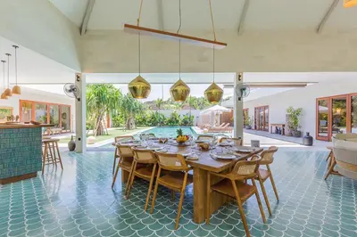 a dining room with a table and a pool at Villa Jinjah Soul Luxury 5BR Villa,18m Pool & Garden in Seminyak