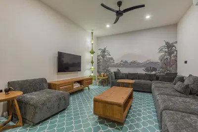 a living room with a couch and a flat screen tv at Villa Jinjah Soul Luxury 5BR Villa,18m Pool & Garden in Seminyak