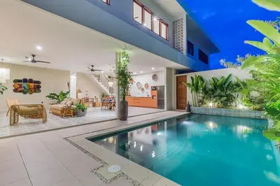 a swimming pool in a house with a living room at Villa Pop Cozy 2BR Villa & Pool Seminyak in Seminyak