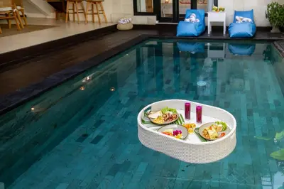 a bowl of food sitting in the middle of a swimming pool at Villa Mandari in Seminyak