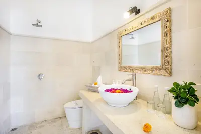 a bathroom with a sink and a mirror at Villa Mandari in Seminyak