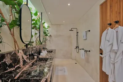a bathroom with a sink and a large mirror at Villa Bali Manis by The Bali Agent - Central Seminyak 4BR Villa with Private Pool, Perfect for Families & Groups in Seminyak