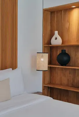 a bedroom with a bed and a shelf with a lamp at Villa Bali Manis by The Bali Agent - Central Seminyak 4BR Villa with Private Pool, Perfect for Families & Groups in Seminyak