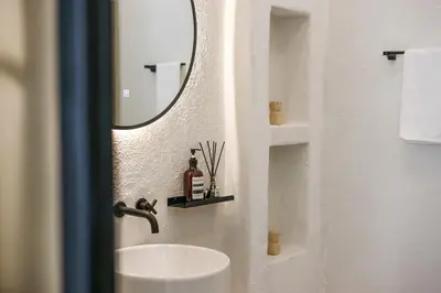 a bathroom with a sink and a mirror at Chic All-White Villa with Pool and Fire Pit in Jimbaran