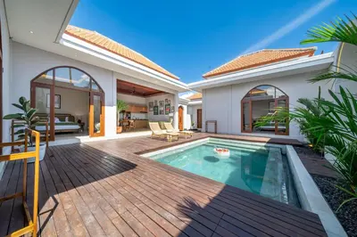 a villa with a swimming pool and a house at Sunterra 2 - Bali Villa Dream with Huge Pool in Kerobokan