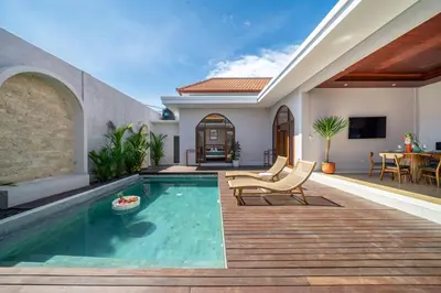 a backyard with a swimming pool and a house at Sunterra 2 - Bali Villa Dream with Huge Pool in Kerobokan